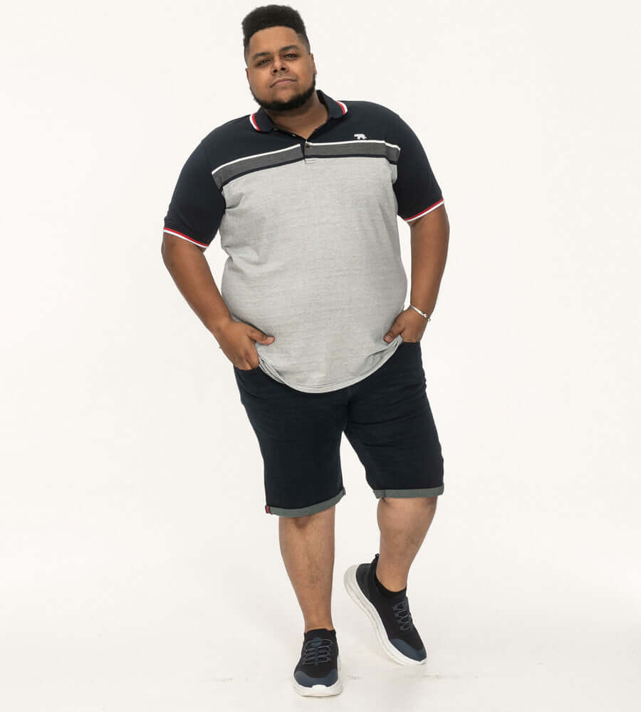Model in Duke Clothing TIPTON striped jacquard polo, perfect for plus-size men, styled with shorts.
